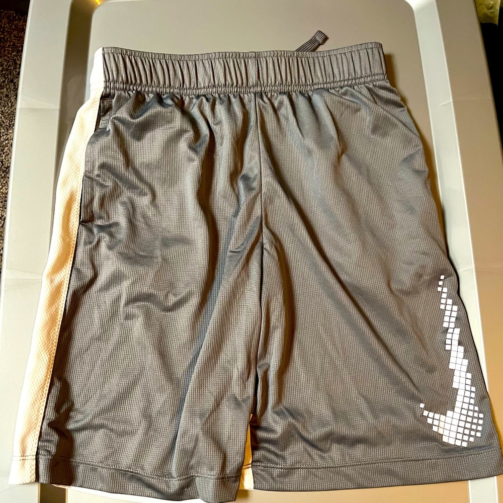Boys Nike size large gray and white dri fit shorts.